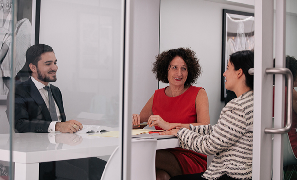 Tania Waterhouse and team working at a desk - Tax Lawyer Sydney Melbourne